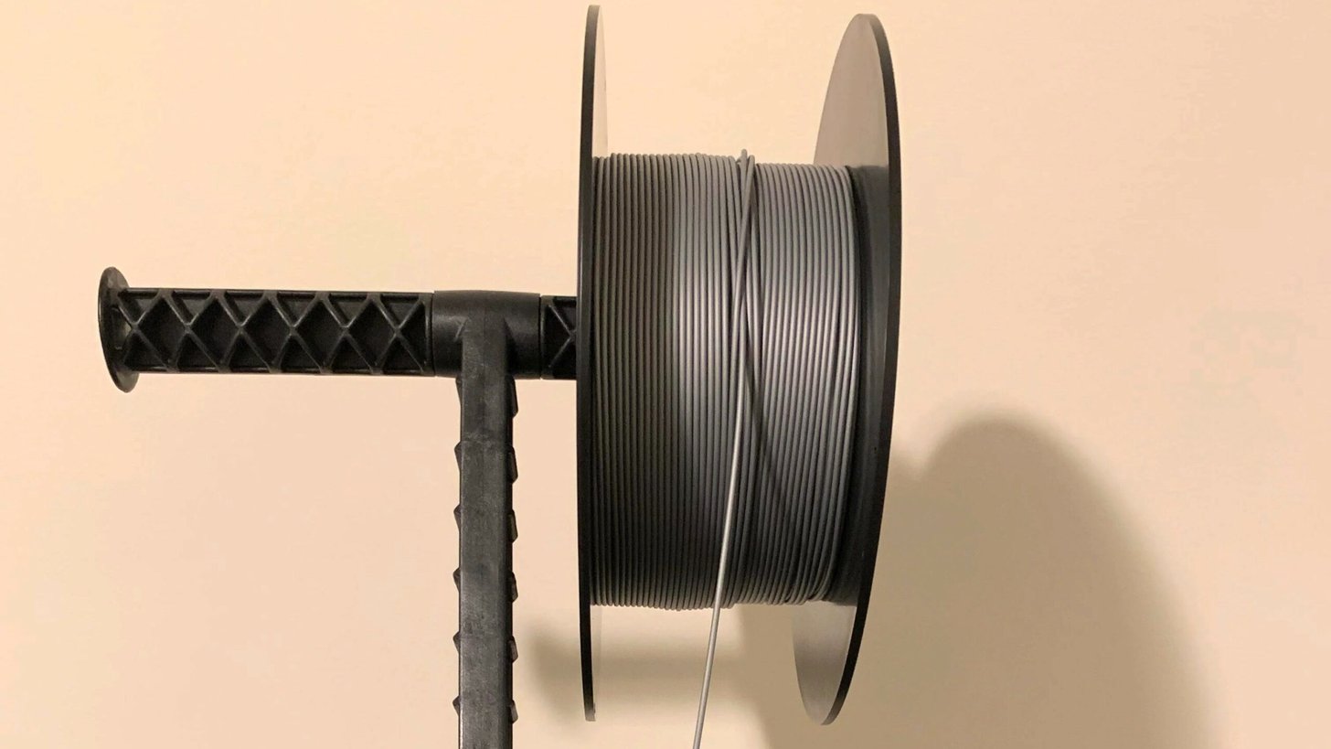 Filament spool with one strand slipped under another — the classic tangle root cause