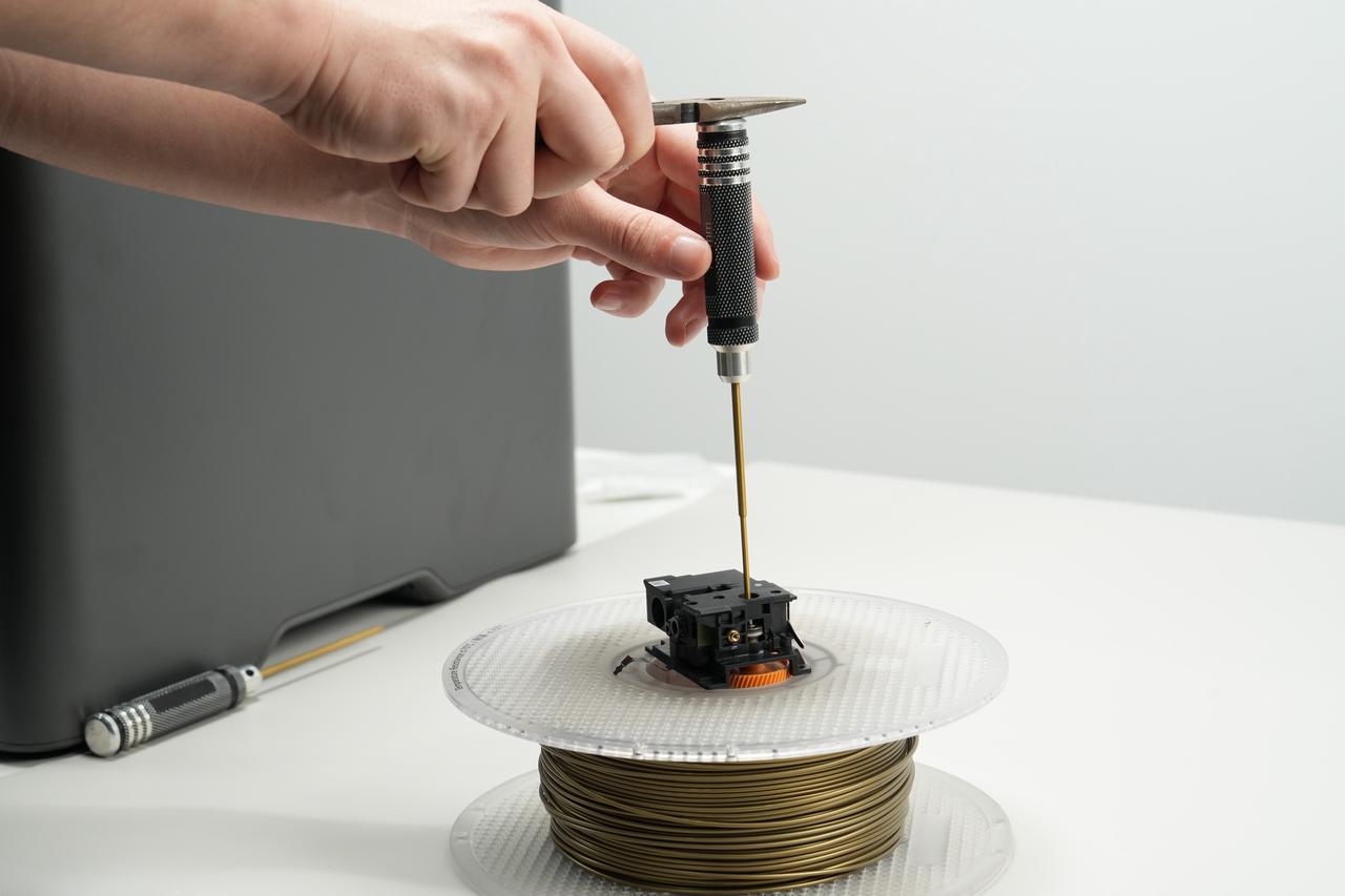Disassembling a removed X2D extruder on top of a filament spool