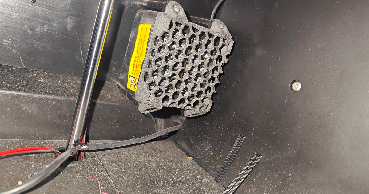 Printed honeycomb cover over the Q1 Pro chamber heater next to a yellow mains warning label
