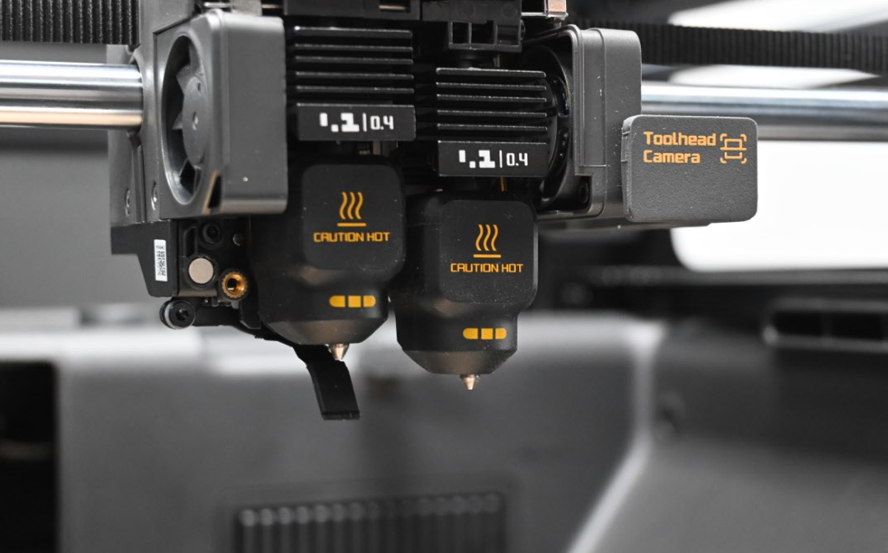Close-up of both X2D hotends with the flow blocker under the left nozzle