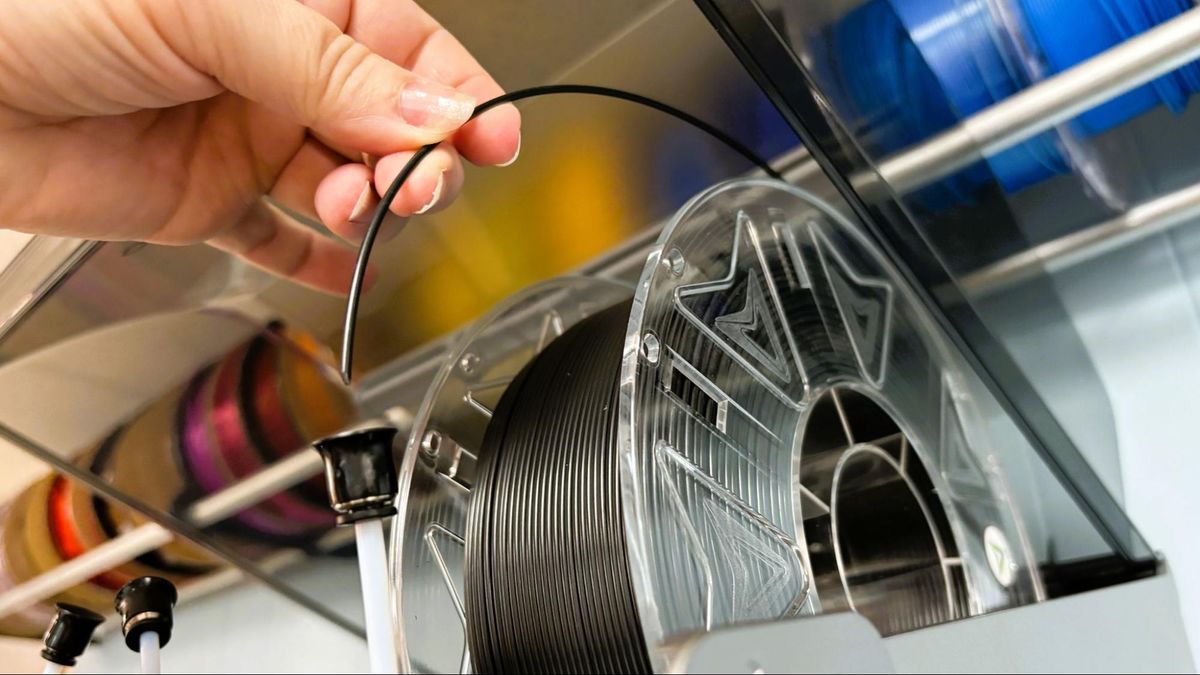 Inserting filament into CFS — from here PTFE goes through the lid to extruder and rubs glass