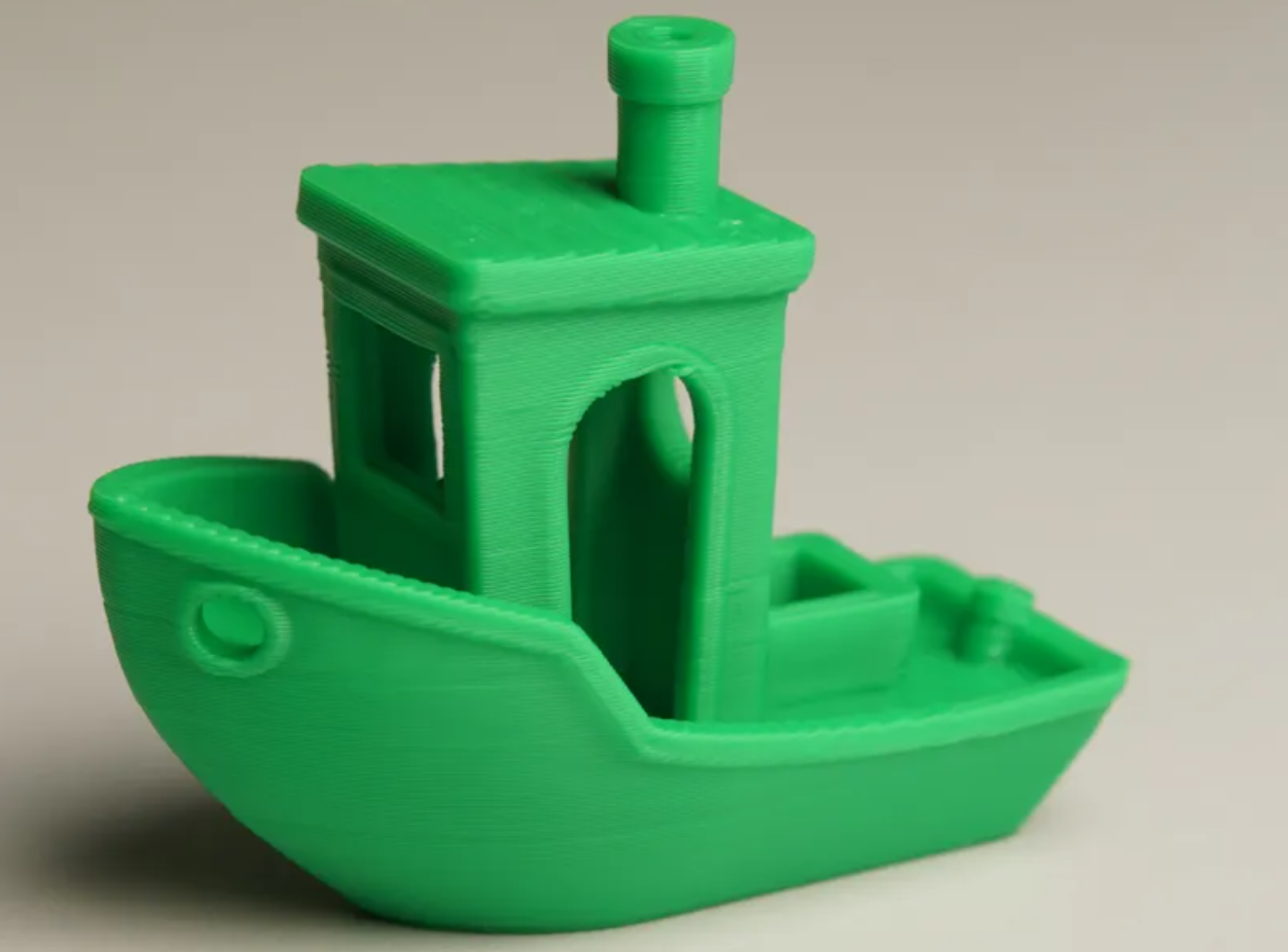 A good benchy first layer — flat, uniform, lines fused, slight bed texture visible