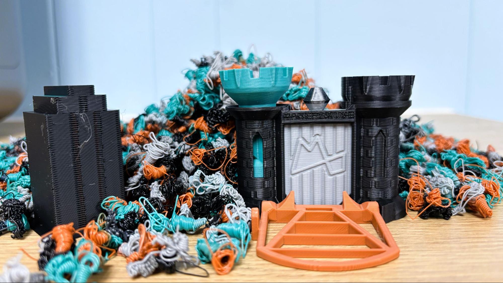 Maker's Muse Clearance Castle — 4-color model surrounded by piles of multi-color filament waste