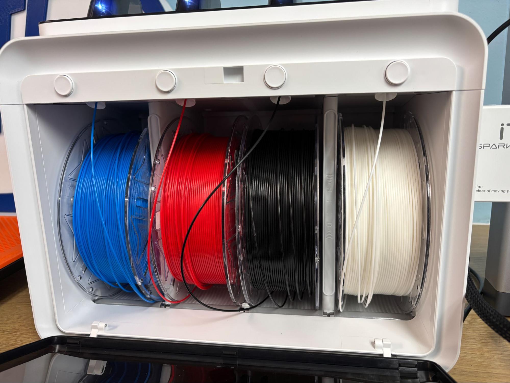 Inside CFS Lite — four free-spinning slots with blue, red, black, white PLA spools