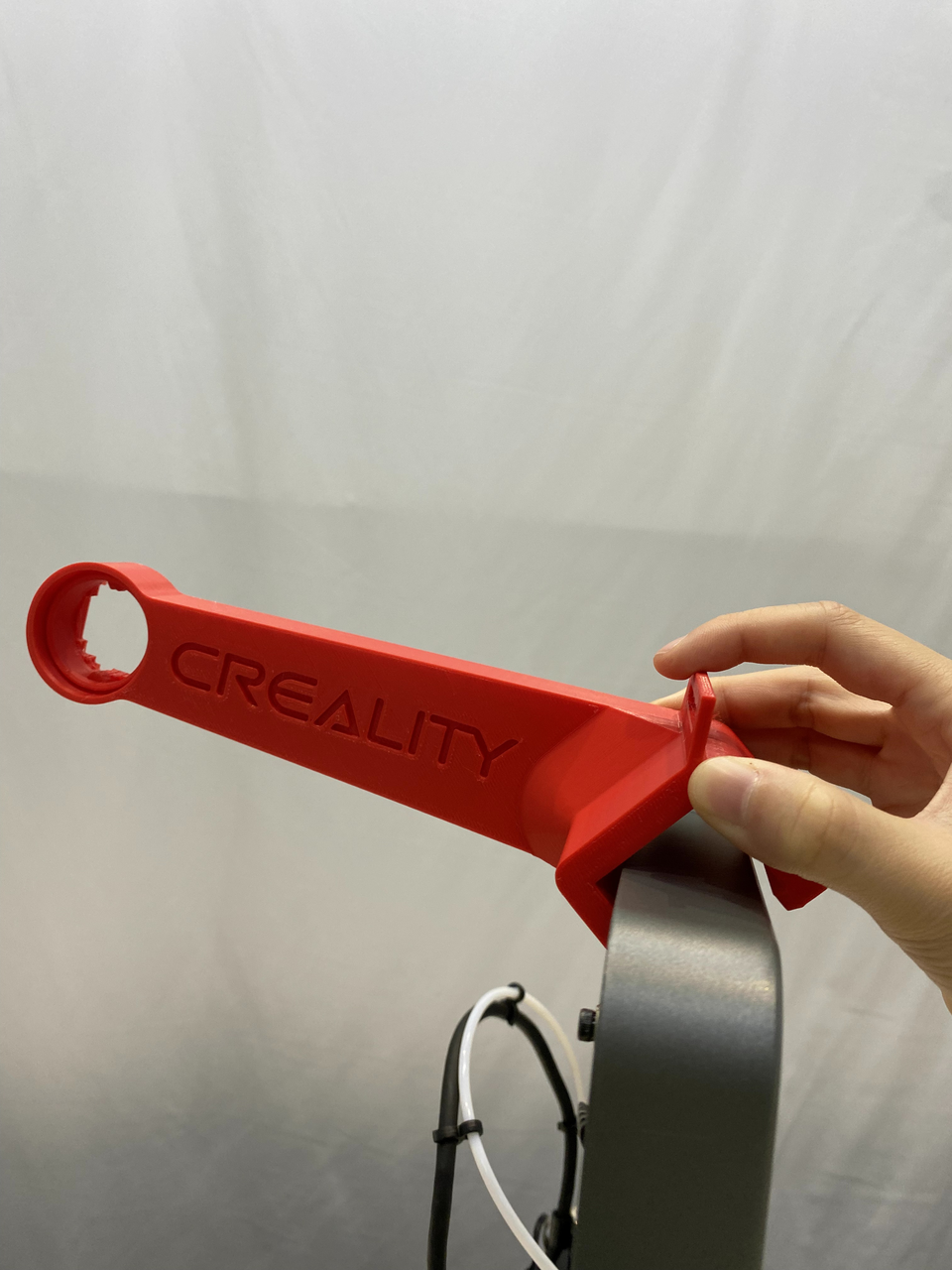 The printed Creality top spool holder for the Ender-3 V3 held in hand