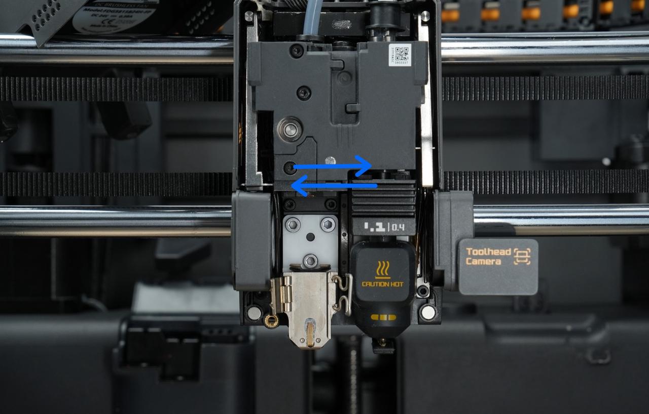 X2D toolhead with the front cover removed showing the cutter assembly and hotend