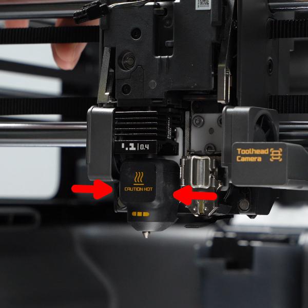 Silicone sock on the X2D left hotend with removal points arrowed