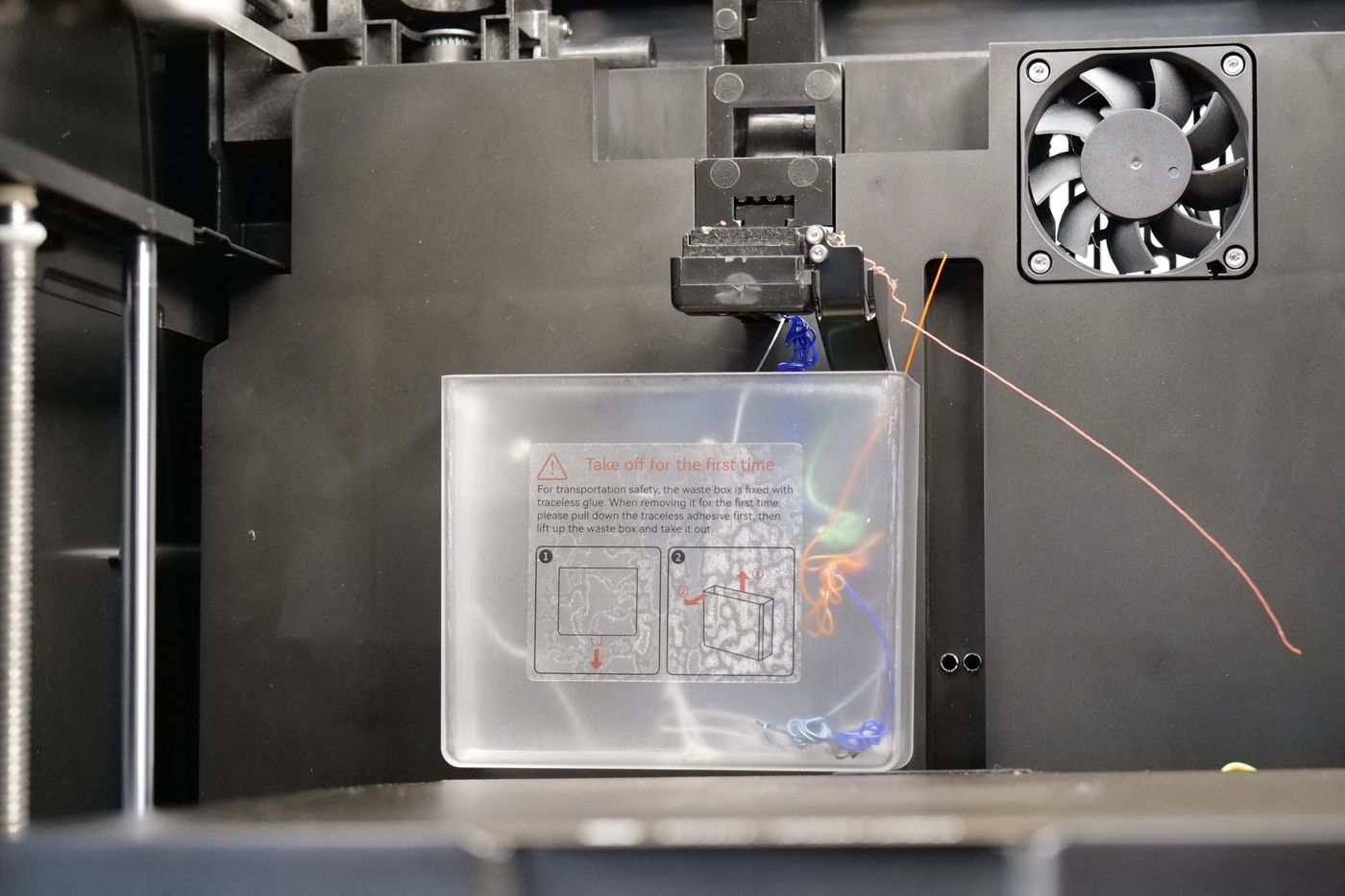 QIDI Q1 Pro nozzle cleaning station and waste bucket where the nozzle wipes on felt before printing