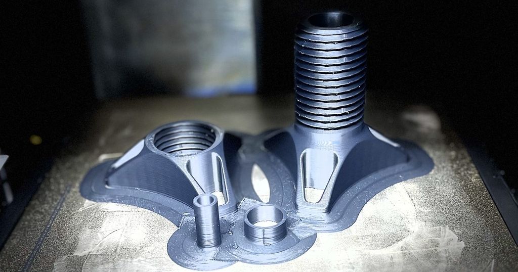 Printed bearing spool holder cones fresh off the build plate