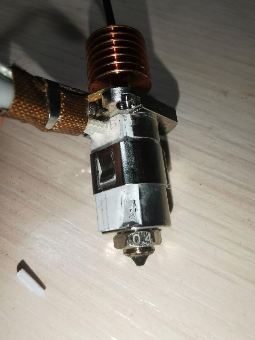 QIDI Q1 Pro hotend assembly with the removed ceramic heater element on the table