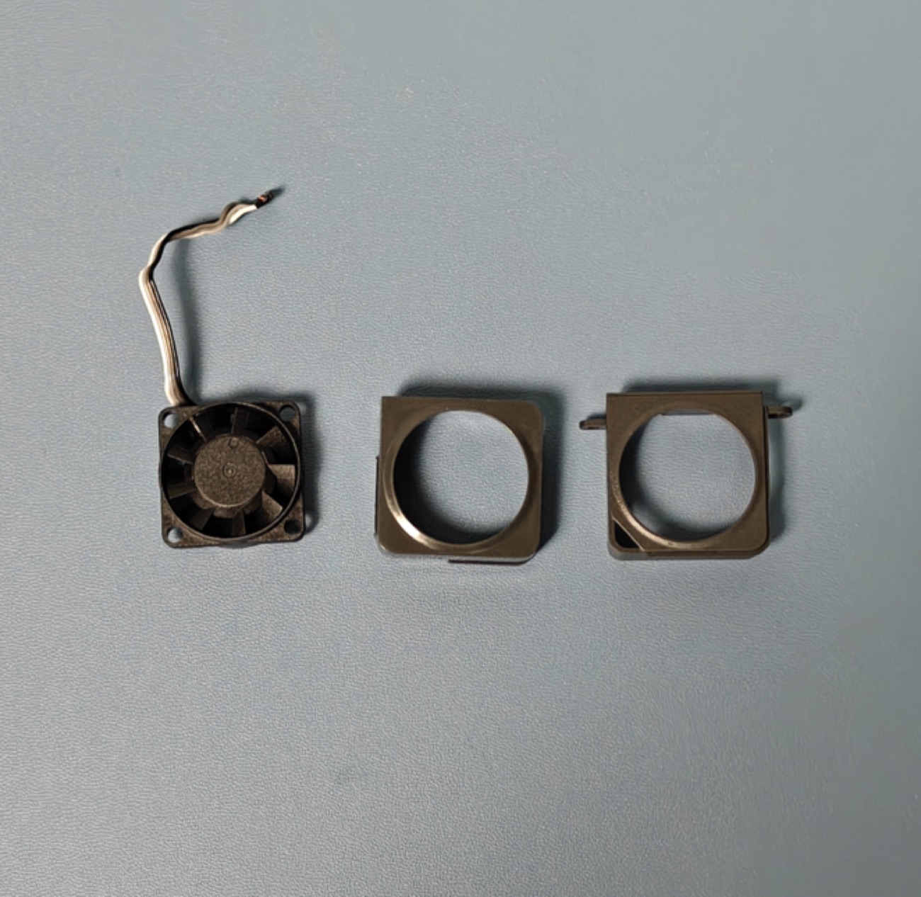 X2D hotend cooling fan next to its two mounting frames